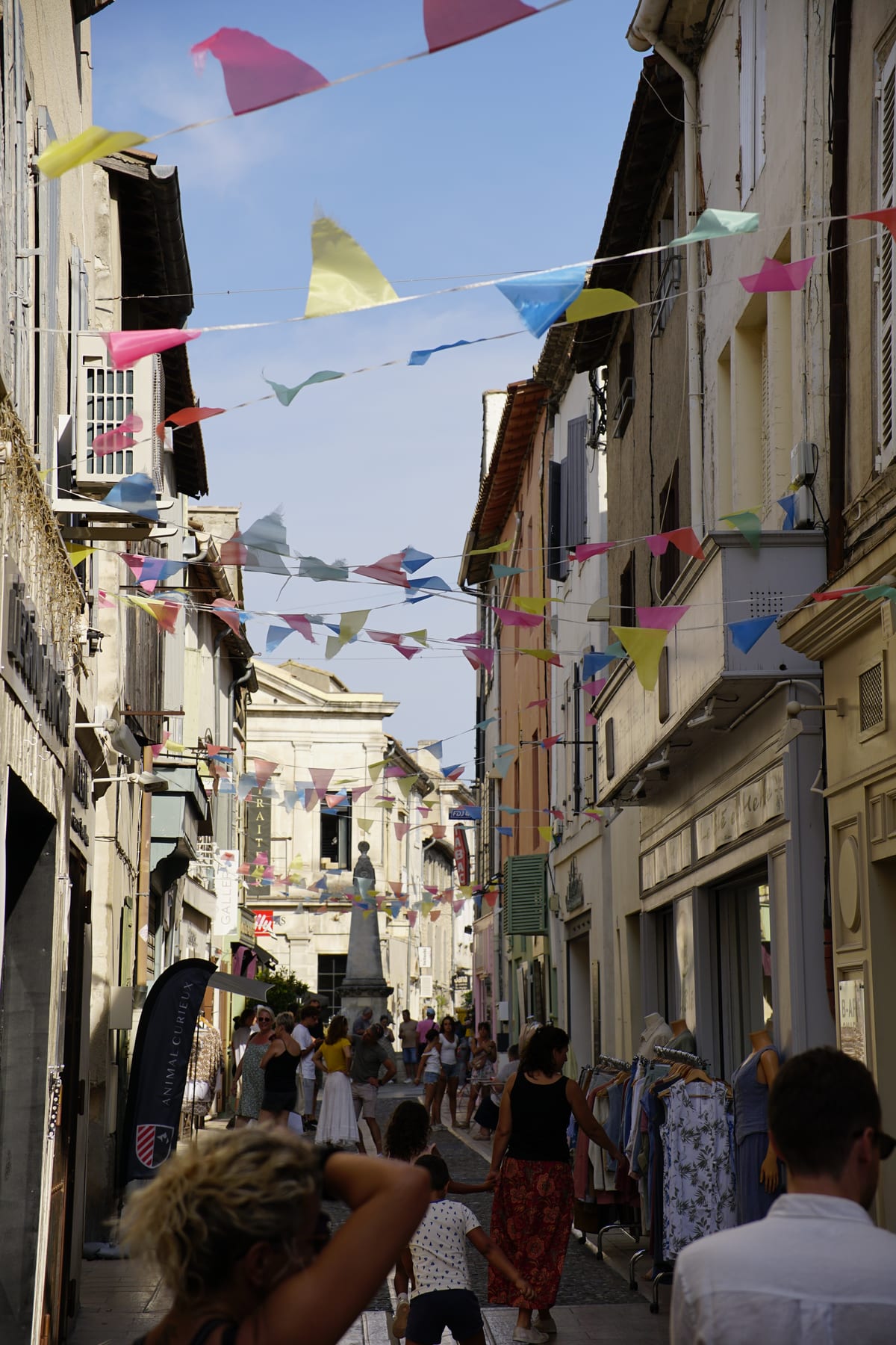 Narrow old-town street under colorful bunting